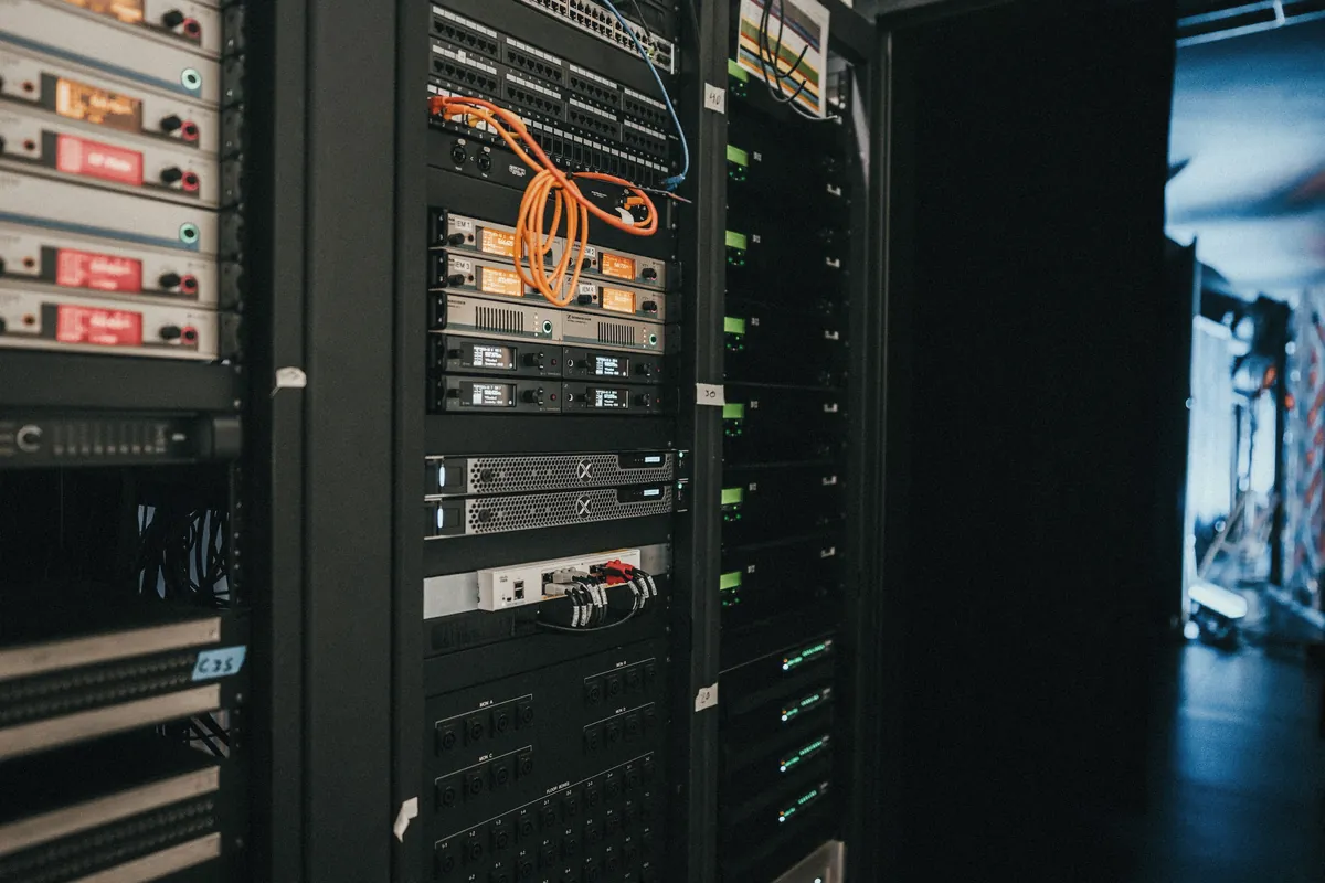 A rack of network switches, patch panels and servers in a small server room