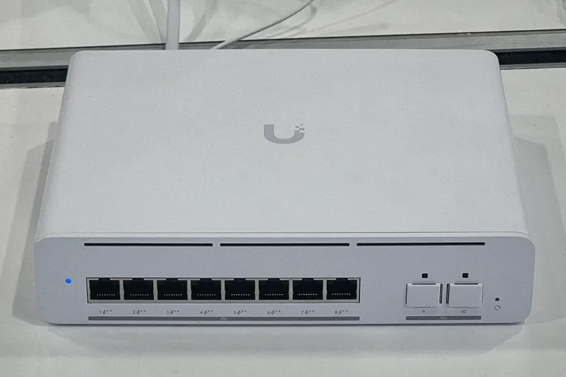 A UniFi Switch Pro XG 8 PoE, a white network switch that also powers access points and cameras